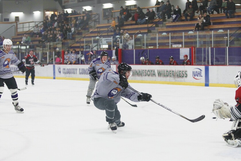 Cloquet-Esko-Carlton alumnus Jeff Leno takes a shot on Duluth East alumnus goaltender Dylan Parker during the third period of the game Saturday, Dec. 1. Stu Plante (13), Justin Jokinen (14) and Tyler Fast (3) watch the play. CEC beat Duluth East during a fun alumni battle ending the week-long Santa's Home for the Holidays festival in Cloquet. Jamie Lund/Pine Journal