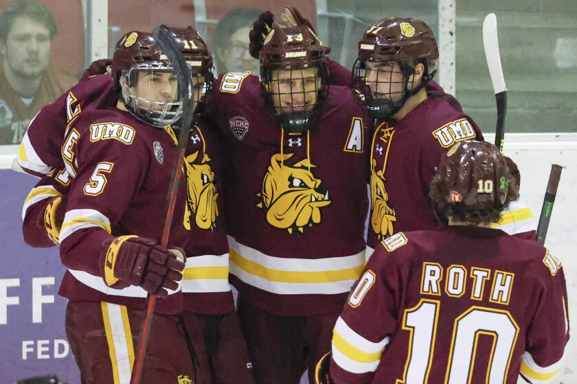 College Men's hockey players compete on Olympic size ice sheet