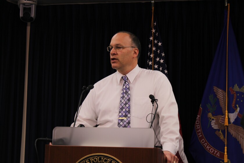 Grand Forks Police Lt. Jim Remer speaks to the media