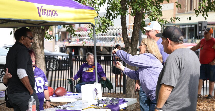 King Turkey Day featured speaker, former Minnesota Vikings Walter Eugene "Chuck" Foreman, also known as "The Spin Doctor," signs an autograph and poses for photos during the celebration Saturday, Sept. 17, 2022, in Worthington.