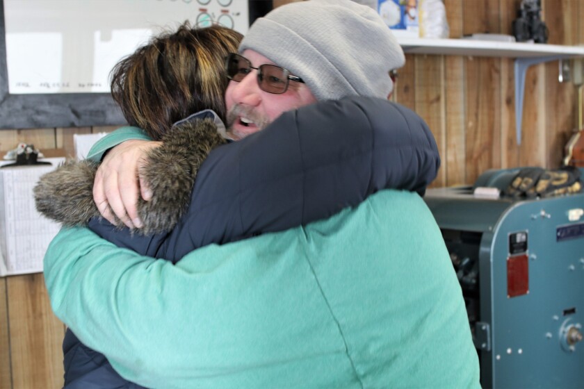 Dawn Chisholm and elevator employee Jeff Boisjolid hug after not seeing each other for years..jpg