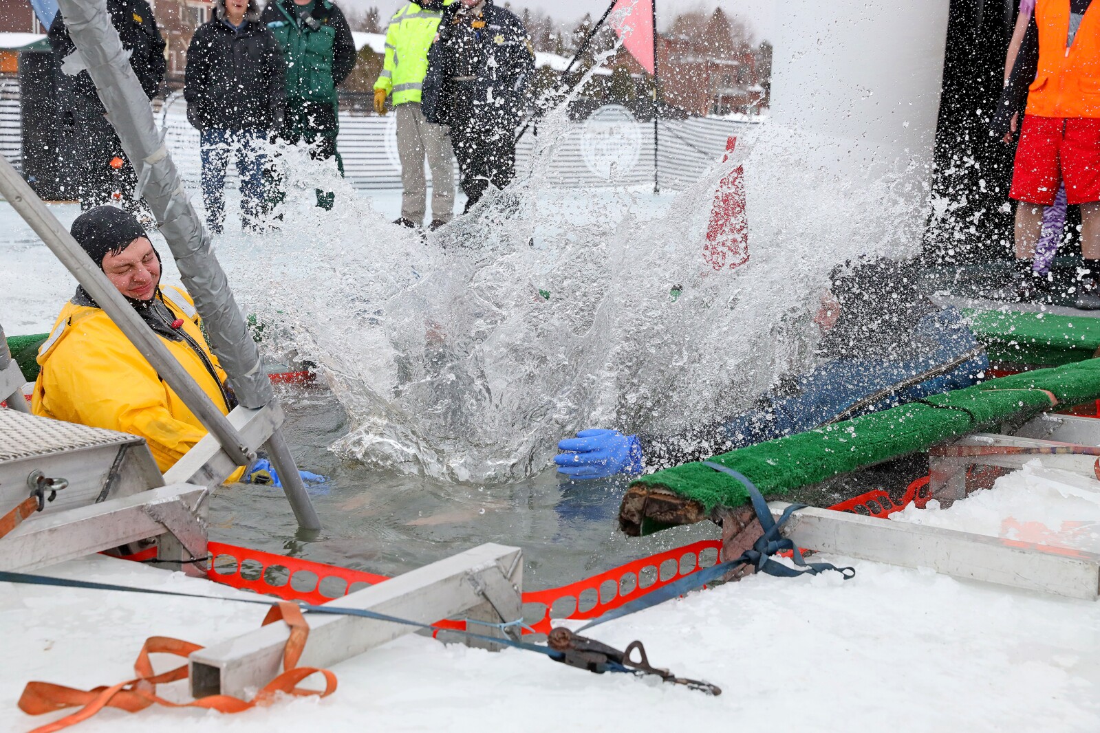 People jump into the water during the Polar Plunge event on Pelican Lake.