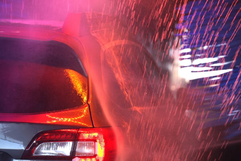 Vehicle goes through car wash