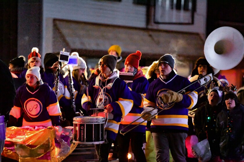 Members of the Cloquet High School band wear layers to stay warm during the Santa's Home for the Holidays parade