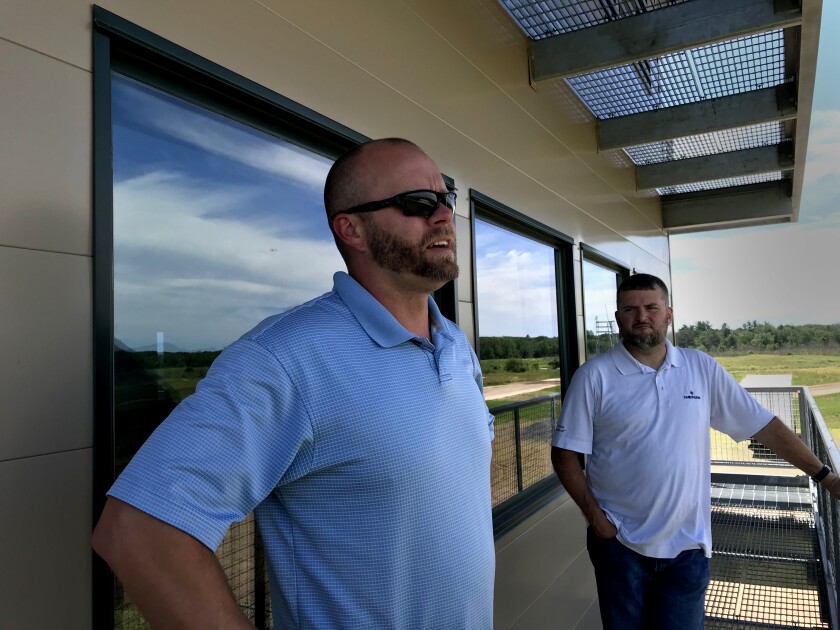 Jake Kitzmann (left), Camp Ripley’s natural resources manager, and Chris Pence, Board of Water and Soil Resources' conservationist, overlook the center range, where an entire platoon can train. Photo by Ann Wessel, BWSR