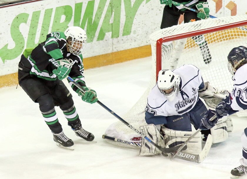 Greenway's Grant Troumbly attempts to stuff the puck in against Hibbing-Chisholm goaltender Christian Renskers during Saturday's Section 7A boys hockey semifinal at Amsoil Arena. (Dave Harwig / For the News Tribune)