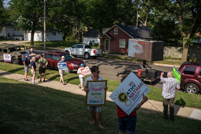 Photos Supporters for opposing school board candidates rally at the