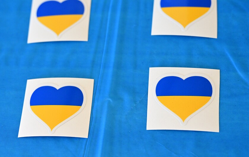 Stickers with the Ukrainian colors are positioned on the table to sell.