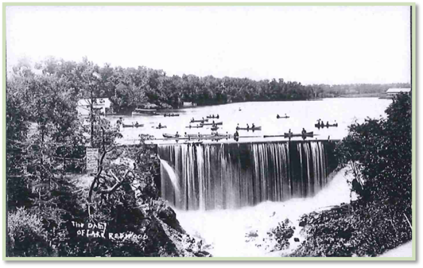 Canoes are shown above the Lake Redwood dam in this historic photo.