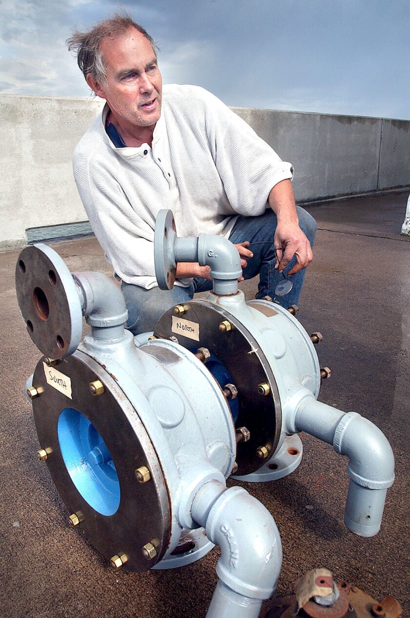 Man posing with two foghorn diaphones