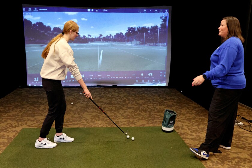 Libby Lake, left, works with Braienrd head coach Karissa Haugen during golf practice on Wednesday, April 9, 2025, at Madden's Resort.