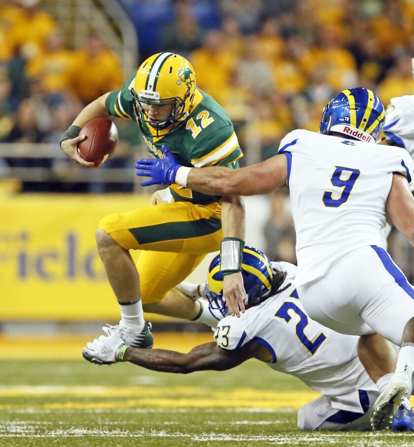 North Dakota State quarterback Easton Stick leaps against Delaware's Nasir Adderley on Saturday at the Fargodome. David Samson / The Forum