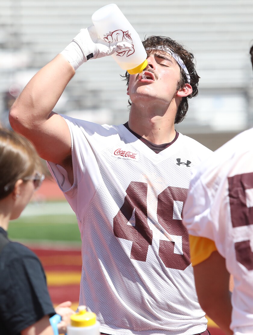 Bulldog linebacker Harrison Kielar (49) gets a drink