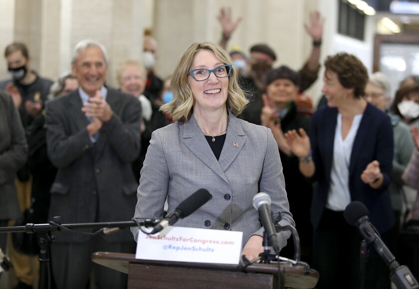 Jen Schultz smiles as the crowd erupts when she officially announces she is running for Congress