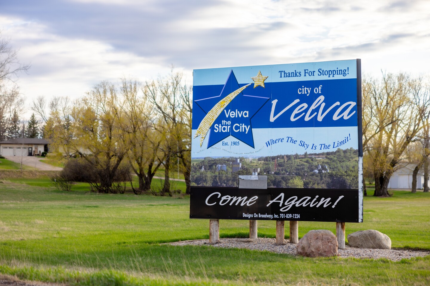 A sign recognizing the town of Velva has a start and points to the town "the star city."