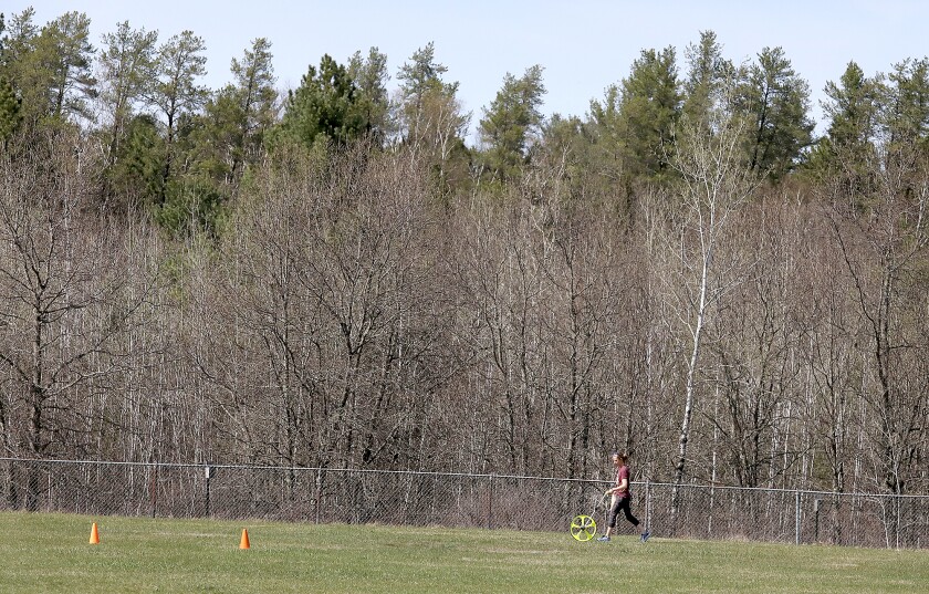 Northwood/Solon Springs’ coach Shannon Dickenson checks on distances before practice