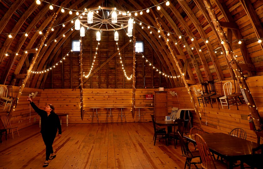 Jill Clemmer points out a spot on the ceiling of the hayloft