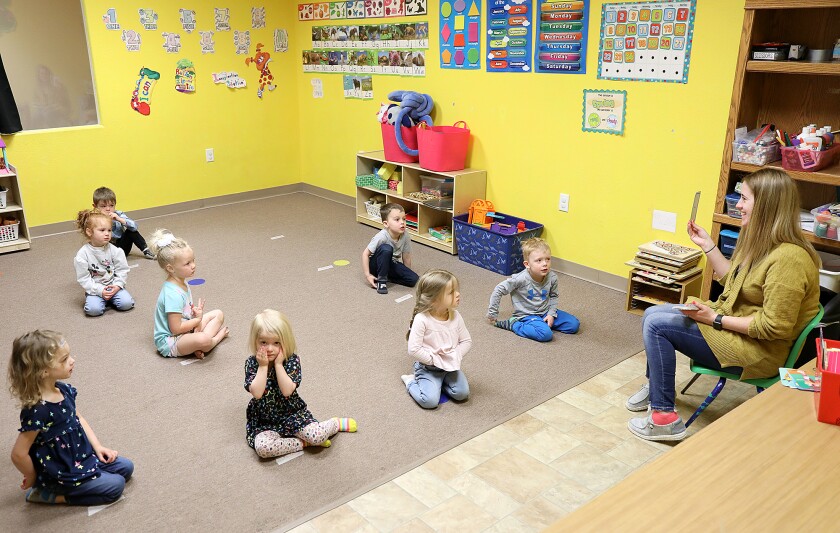 Megan Moore holds up flashcards to children in the three year old room at Shell’s Daycare