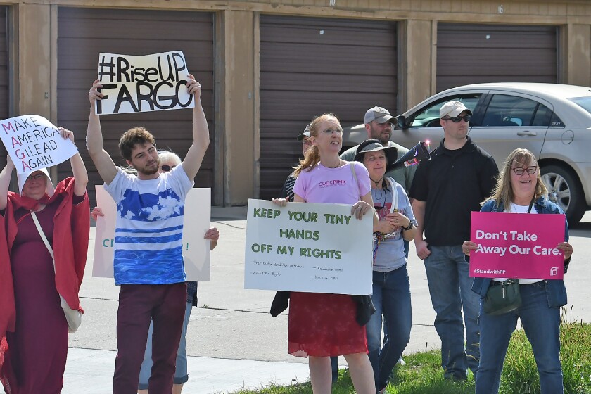 Jamaal Abegaz leads a chant by protesters during President Donald Trump’s appearance Friday, Sept. 7, at Delta Hotels by Marriott, Fargo. Michael Vosburg / Forum Photo Editor