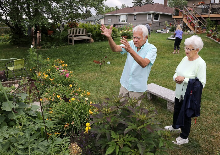 Greg Bonovetz, left, talks about his garden with Darlene Johnson during a sneak peak Tuesday afternoon