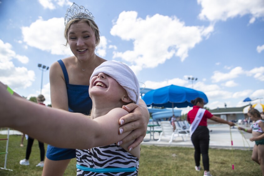 Willmar Fest queen of 2021 Sarah Carlson helps guide a dizzy Avery Van Eps, 8, while playing a game of pin the tail on the donkey, queen edition, during the Queen's Splash at Dorothy Olson Aquatic Center on Wednesday, June 22, 2022.