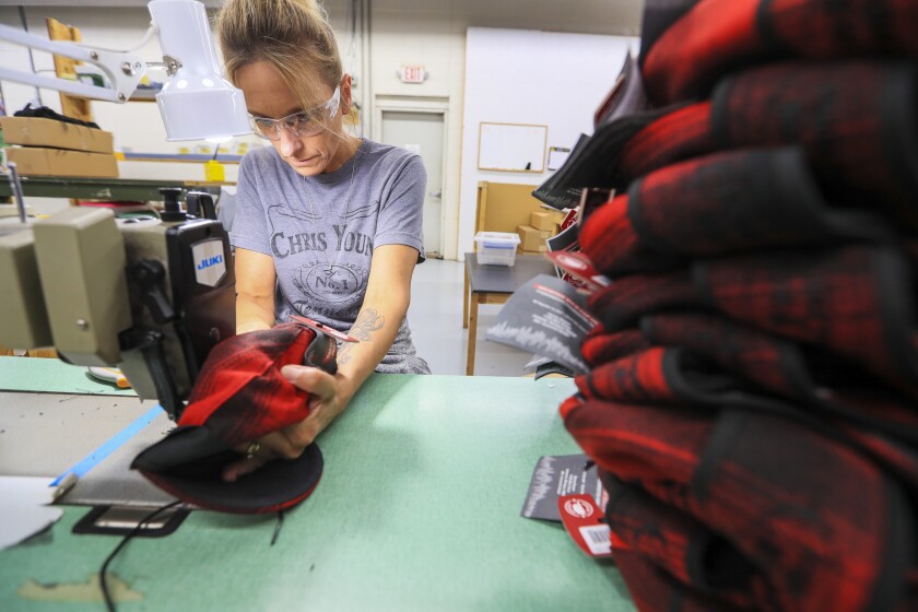 Wool caps with ear bands being made in factory