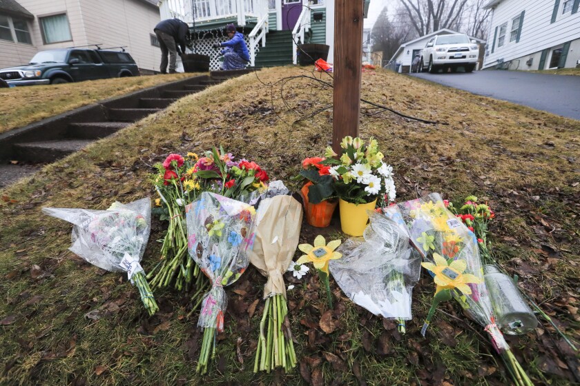 Community members gather to light the Barry home in the East Hillside neighborhood of Duluth