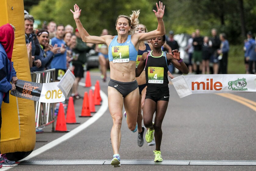Clint Austin / caustin@duluthnews.comHeather Kampf of Minneapolis celebrates as she crosses the Minnesota Mile finish line on Skyline Parkway on Thursday evening. Kampf won the women's division with a time of 4 minutes, 41.6 seconds.