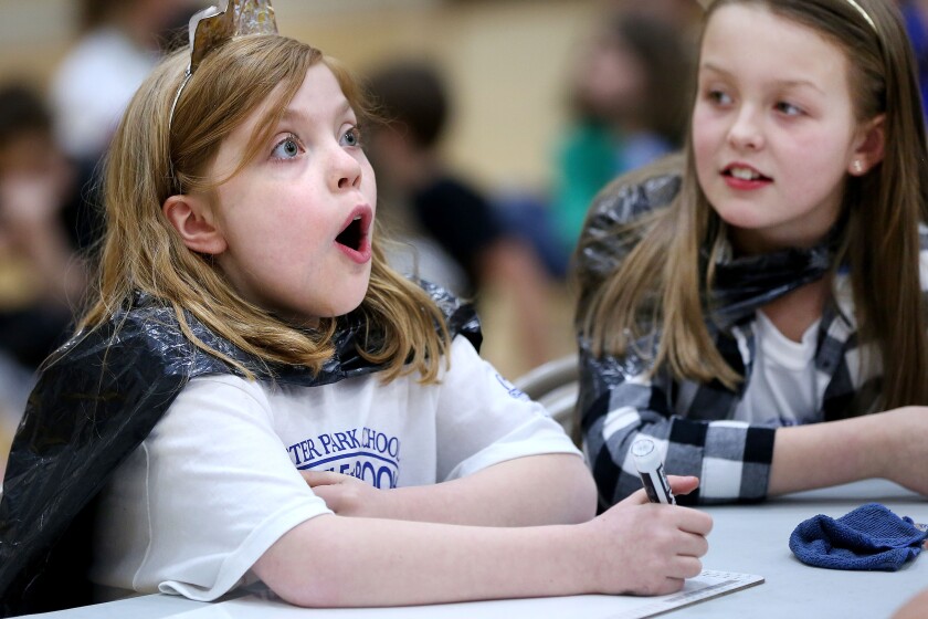 Fourth-grader Caroline Eaton (left) of the Royal Readers team has a sudden revelation on what might be the correct answer during the Lester Park Elementary School's 10th annual Battle of the Books on Friday. At right is teammate Madeline Hall. Bob King / rking@duluthnews.com