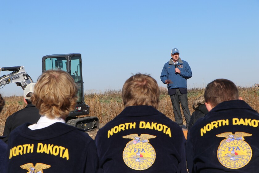 Students in FFA jackets listen while U.S. Sen. John Hoeven, R-N.D., addresses a crowd of 300 at the Grand Farm groundbreaking.