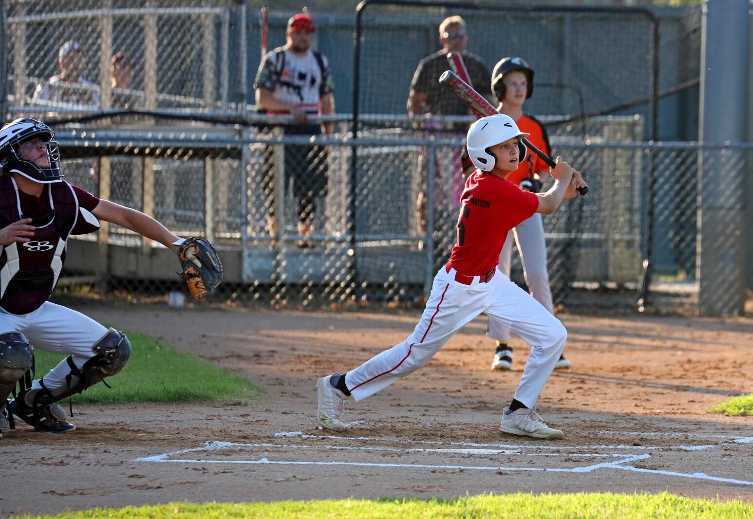 Baseball player hits the ball.