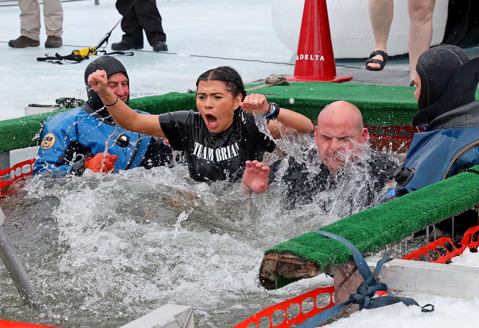 People jump into the water during the Polar Plunge event on Pelican Lake.