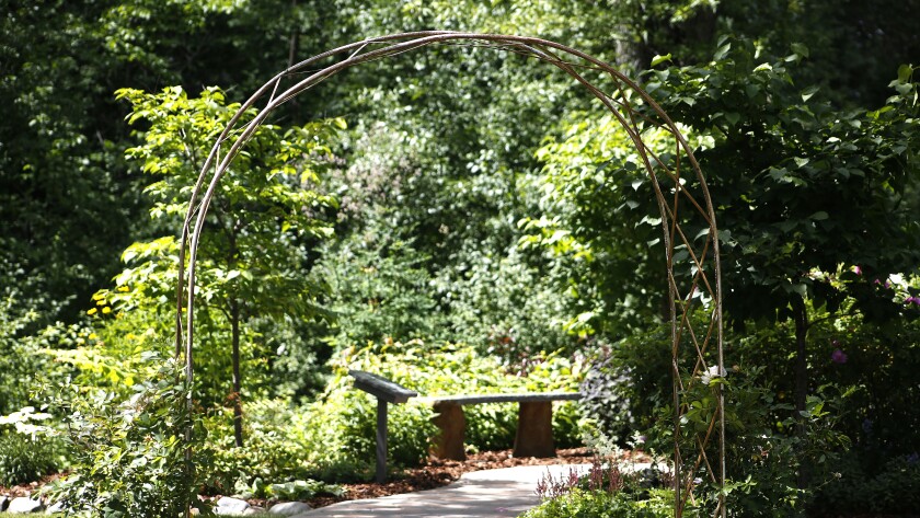 Archway in front of garden.