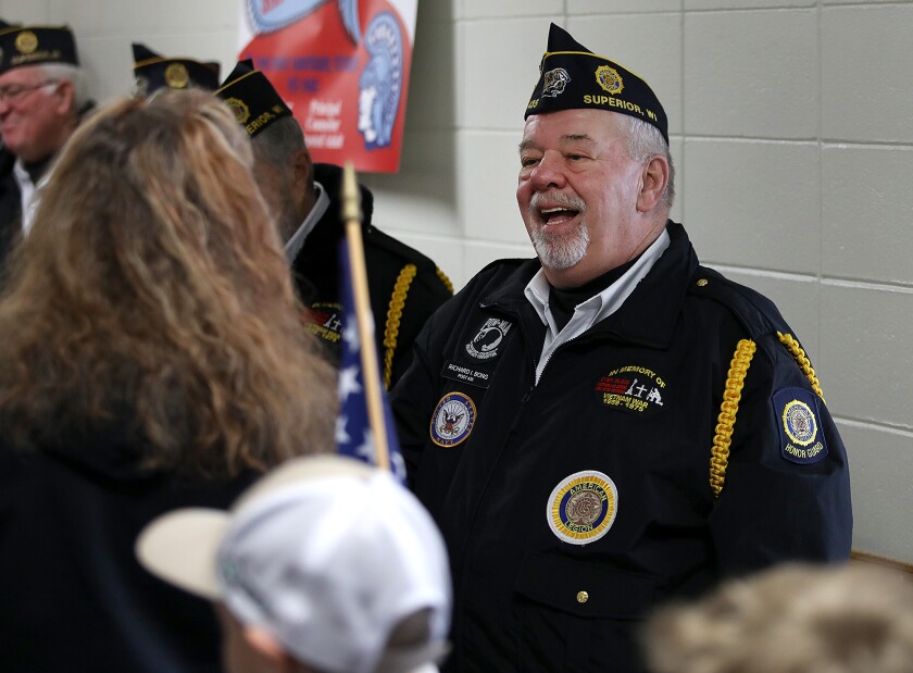 Vietnam veteran Joseph Wojtoff, right, talks with students and staff members at Great Lakes Elementary School