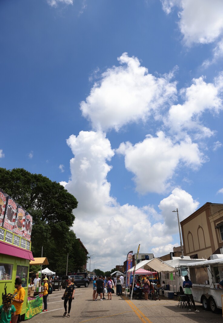White clouds in a blue sky float over the food court down Second Avenue in Worthington at the International Festival on Saturday, July 9, 2022.