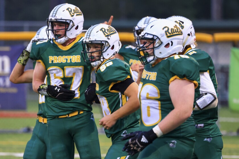 Football players and fans at outdoor high school game