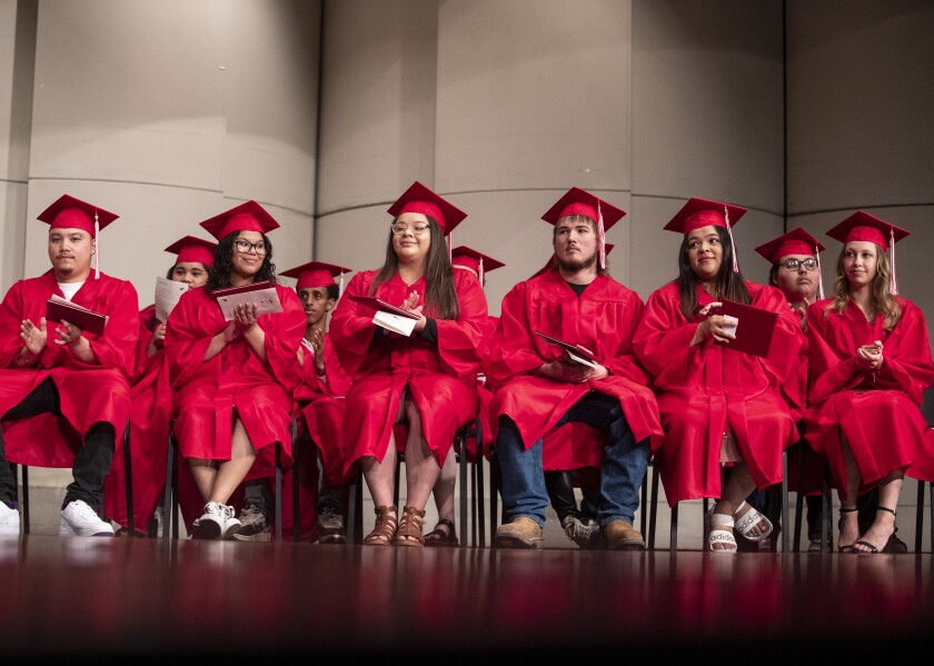 The Area Learning Center Class of 2022 sits on stage after being handed their diplomas during the school's senior graduation ceremony on Thursday, May 19, 2022.