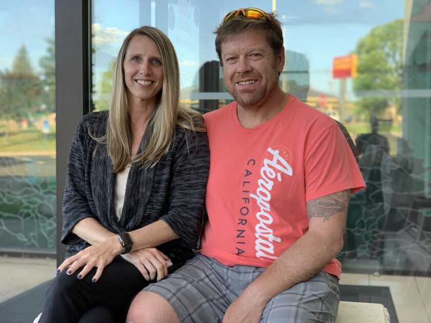 Lisa Valiant and Mike Hennessey sit together for photo