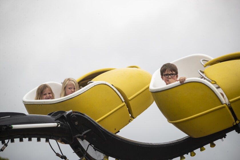 Children patiently wait for a ride to begin at the Kandiyohi County Fair on Saturday, August 13, 2022.