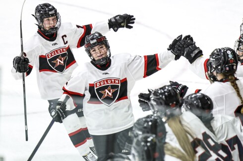 high school girls play ice hockey