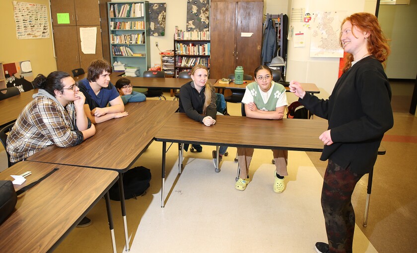 Students watch as teammate performs forensics piece.