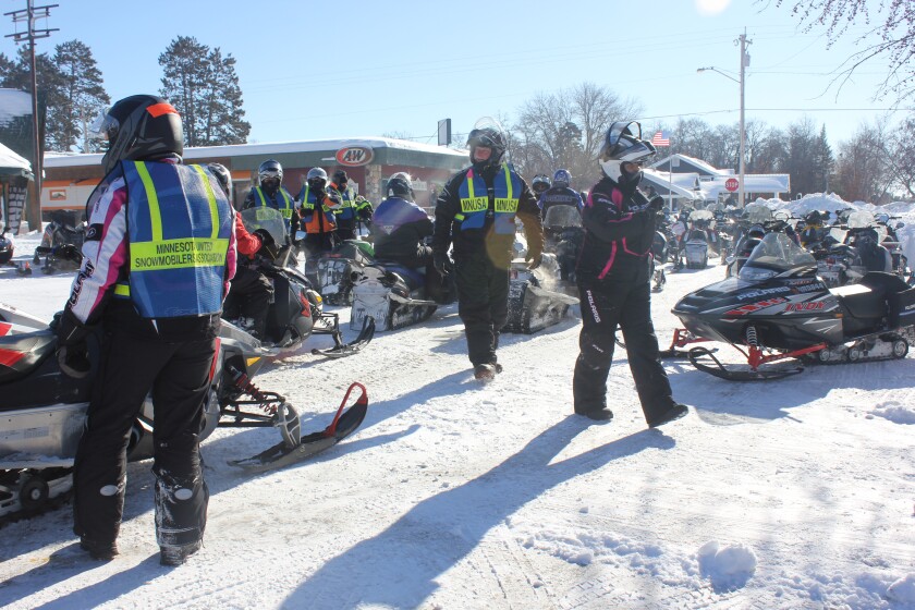 Snowmobilers with the Minnesota United Snowmobile Association take a trail break in Nisswa.
