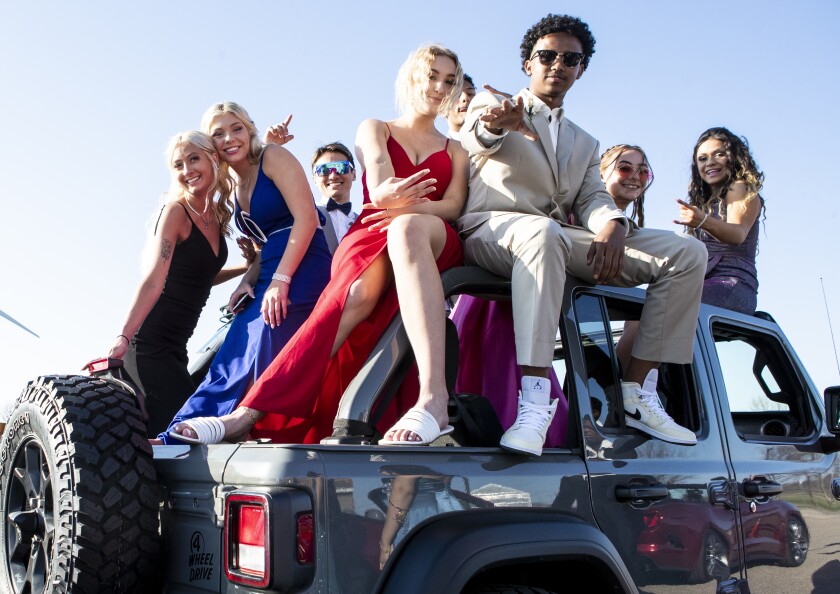 Students hang out on the roof of a Jeep while waiting for grand march for this year's prom to begin at Willmar High School on Friday, May 6, 2022.