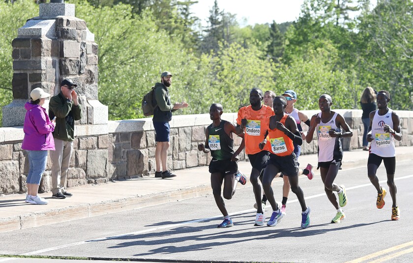 Eventual winner Dominic Ondoro and the lead pack run over the Lester River Bridge