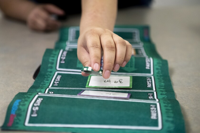 Angel Rios, 15, places a bet while playing Wits and Wagers during a Teen Gaming Club gathering at the Willmar Public Library Friday, Feb. 11, 2022.