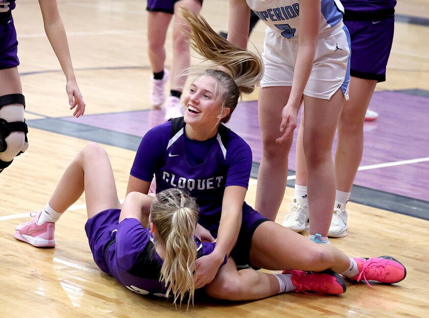 Player laughs with teammate on floor.