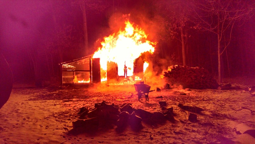 An out building containing a wood boiler near Rep.-elect Josh Heintzeman's Nisswa home is destroyed by fire Nov. 28 The fire created enough smoke damage in his home that the family of seven had to temporarily move into a motel. Submitted photo