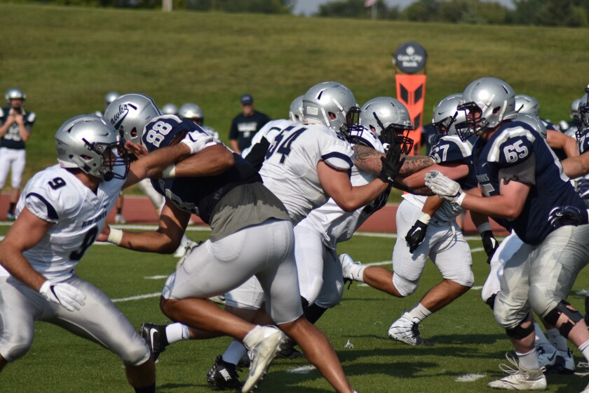DSU junior defensive lineman Matthew Perez (54) competes against John Haraldson (65) on the offensive line in a scrimmage on Friday, Aug. 24, at the Biesiot Activities Center. (Shelby Reardon / The Dickinson Press)