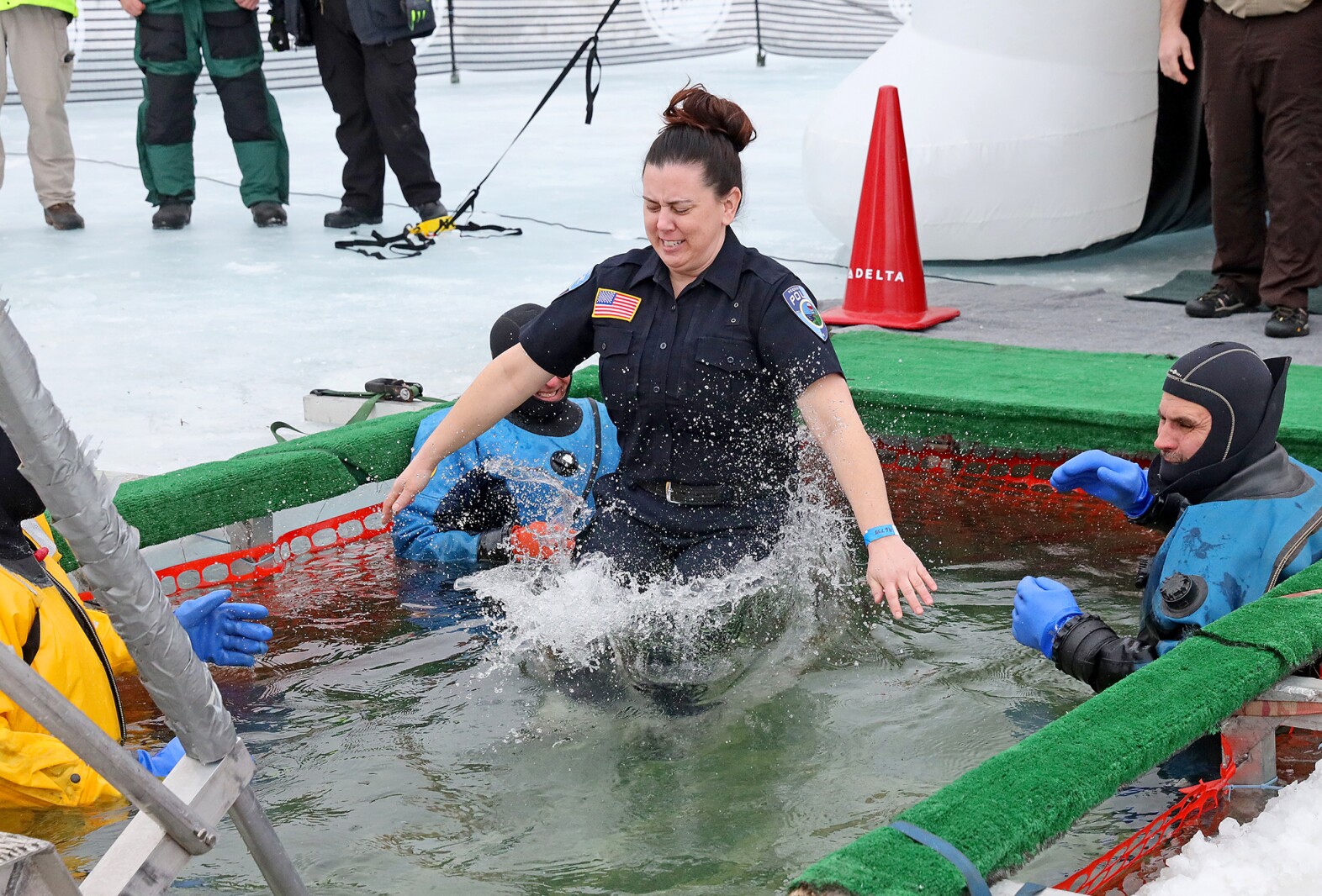 People jump into the water during the Polar Plunge event on Pelican Lake.