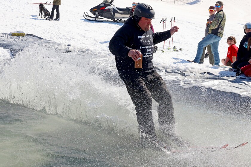Skiers and snowboarders participate in the water skip at Mount Ski Gull on Saturday, April 8, 2023, for the end of the season.